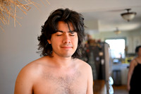 A young man with bushy hair and no shirt